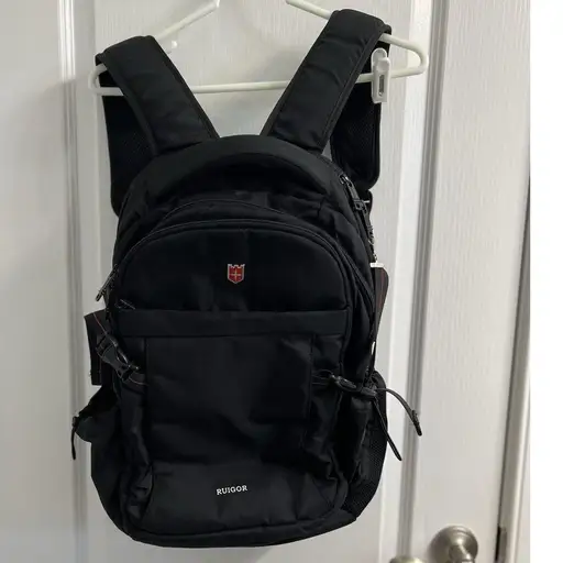 Ruigor Icon Series RGB6424 Black Laptop Backpack 15.6 USB Port 28 Qt Tech Bag

Ruigor Icon Series RGB6424 backpack offers a sleek, professional design in water-repellant black polyester. Engineered for the modern commuter, it features a dedicated compartment for a 15.6-inch laptop and an integrated USB charging port. The multi-chamber organization includes a safe pocket for valuables and external side pockets.

Brand: Ruigor
Series: Icon Series
Model: RGB6424
Material: Water-repellant Polyester
Capacity: 28 Qt
Color: Black with Red Accents
Laptop Sleeve: Fits up to 15.6"
Features: USB Port, Multi-chamber Organization, Safe Pocket
Closure: Zipper
Hardware: Plastic Buckles and Metal Zippers
Pockets: External Mesh, Front Zip, Internal Organizer

Keywords: Techwear, Commuter, Business Travel, Laptop Bag, Swiss Design, Ergonomic, Water Resistant, Professional, School Bag, Charging Port, Minimalist, Tactical Aesthetic, Utility, EDC

#Travel #Nylon