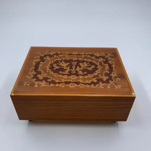 Vtg Sorrento Italian Inlaid Wood Music Jewelry Box Sankyo Isle of Capri Working

Vintage wooden music box features a stunning inlaid marquetry design on the lid with intricate scrollwork and bird motifs. The interior is divided into two sections, one with a wooden cover, perfect for storing small jewelry or keepsakes. It plays the classic tune "Isle of Capri" and stands on four black tapered feet. The wind-up mechanism on the bottom is marked with an "S" logo, indicating a Sankyo movement.

Brand: Sankyo
Product Type: Music Box
Material: Wood
Design: Marquetry Inlay
Tune: Isle of Capri
Color: Brown
Features: Footed, Divided Interior
Style: Vintage, Traditional
Origin: Italian (Sorrento Woodwork, Japanese Movement)
Mechanism: Wind-up

Keywords: Sorrento, Reuge style, cottagecore, grandmacore, jewelry chest, keepsake box, musical decor, wood craft, floral inlay, bird design, mid century, vanity accessory, collectible music box, melodic gift, classic tune

I do try my best to ma

#Neutral