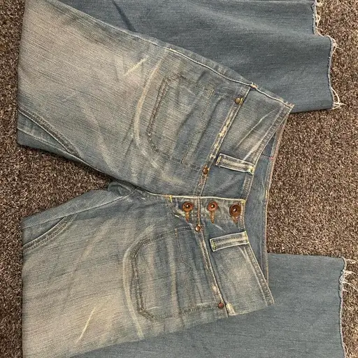 Blue denim jeans with a distressed look #distressed #denim