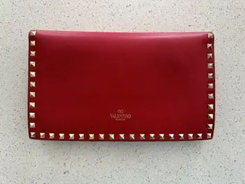 Valentino Garavani Rockstud leather clutch bag red