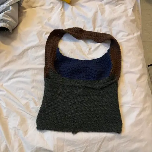 Handmade crochet halter crop top with brown, blue, and dark green sections, tagged EL bc itt’s sorta EL vibes